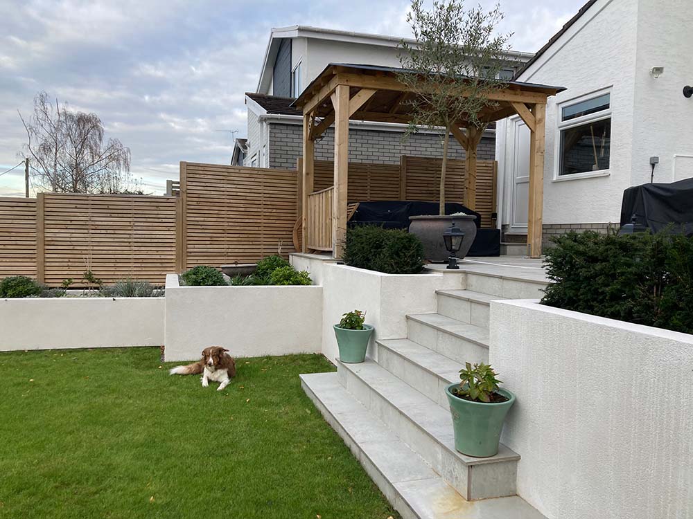 porcelain patio, rendered raised planters and bespoke pergola | Landscaping Monmouthshire